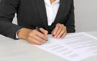 Junge Frau unterzeichnet Arbeitsvertrag